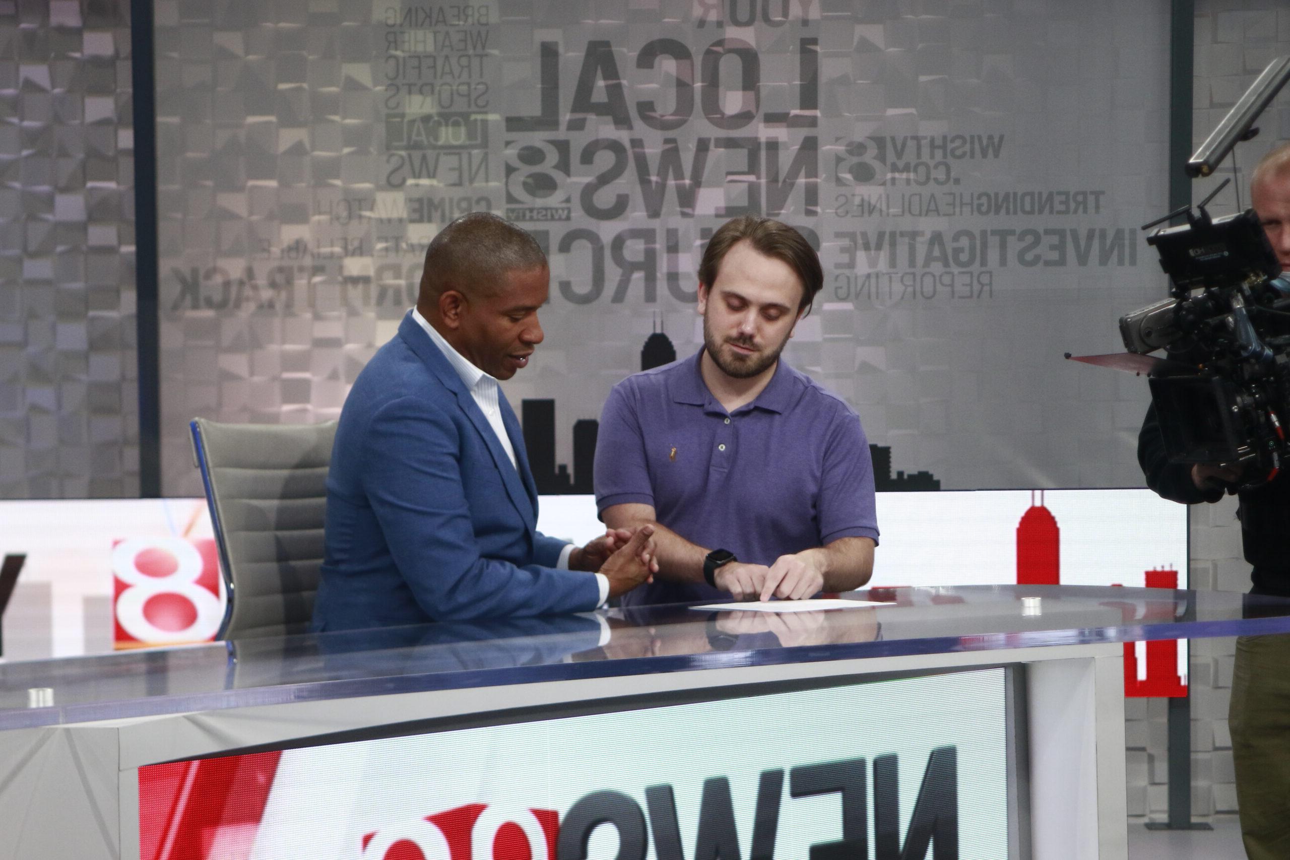 Male student intern at WISH-TV Indianapolis in news desk.